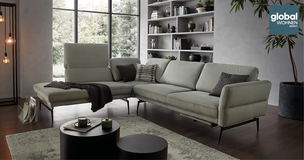 Lesende Frau auf hellgrauem Global Select Sofa mit Liegeflaeche